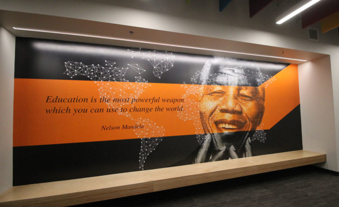 Pearson - Inspirational wall mural featuring Nelson Mandela’s quote: ‘Education is the most powerful weapon which you can use to change the world,’ with a geometric world map design.