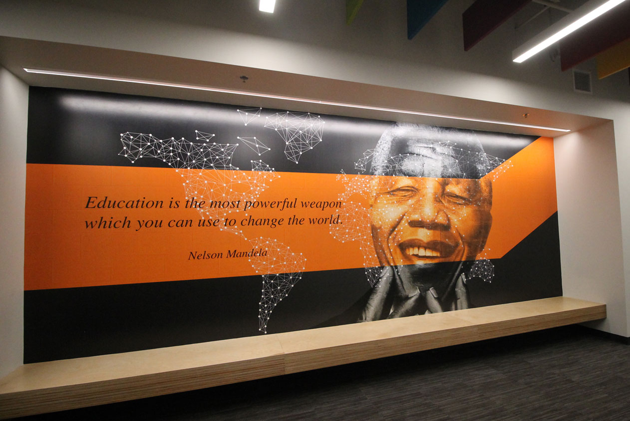 Pearson - Inspirational wall mural featuring Nelson Mandela’s quote: ‘Education is the most powerful weapon which you can use to change the world,’ with a geometric world map design.