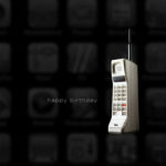 Retro mobile phone on a dark app icon background with the words ‘Happy Birthday’ displayed, celebrating technology evolution.