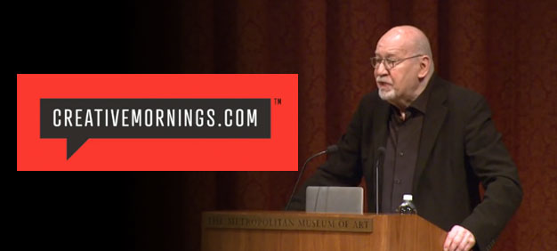 Speaker delivering a talk at a CreativeMornings.com event, standing at a podium with a red and black logo displayed