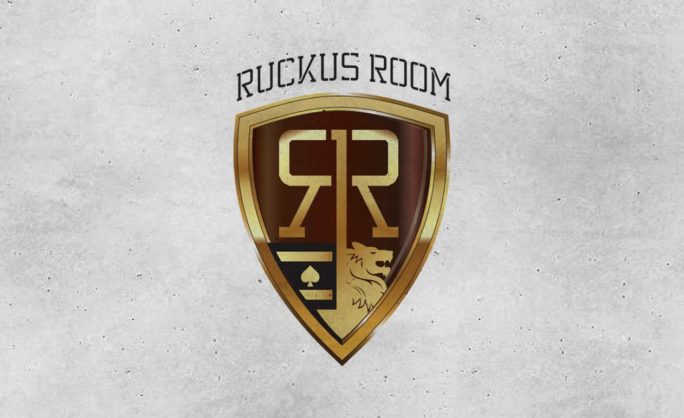 Ruckus Room - Ruckus Room Logo featuring a gold shield design with a lion and spade emblem