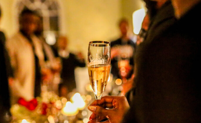 a person holding a glass of champagne