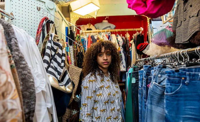 a woman standing in a clothing store